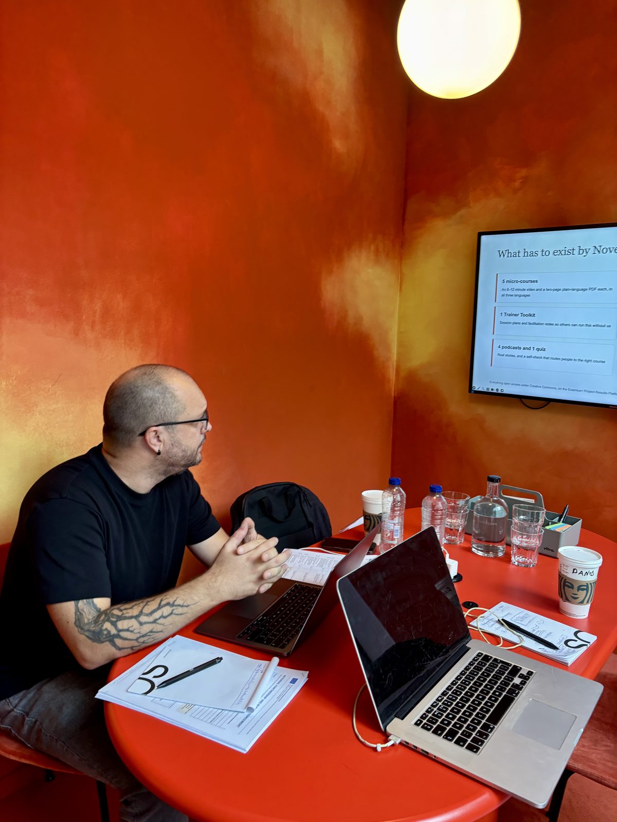 A partner reviewing the project plan on a laptop during the kick-off meeting.